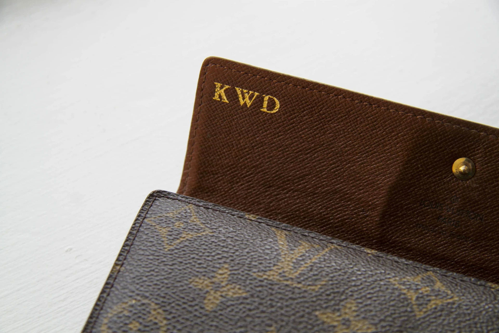 My Louis Vuitton monogram wallet with my initials hot stamped in gold.