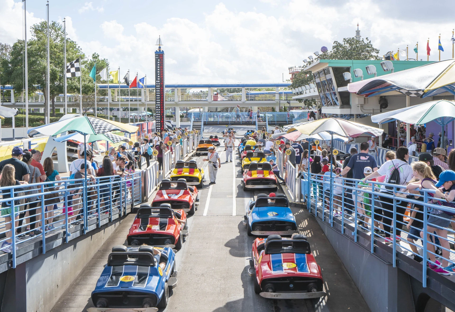 People line up to drive the Autopia cars at Magic Kingdom, one of the best things to do in Orlando.