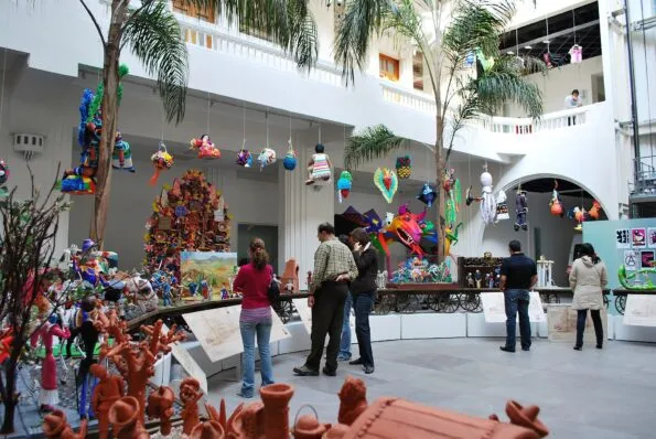 Guests at Museo de Arte Popular admire a Dia de los Muertos train display.