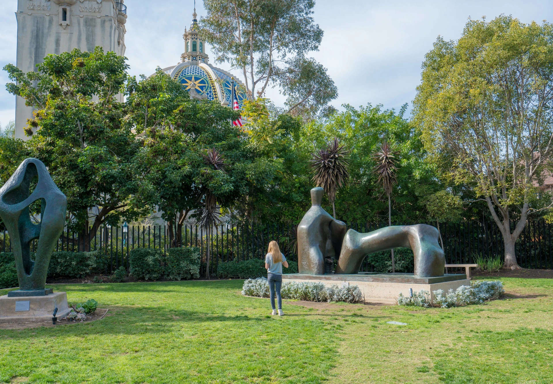 My daughter walks through the sculpture garden at Panama 66, a kid-friendly San Diego restaurant in Balboa Park.