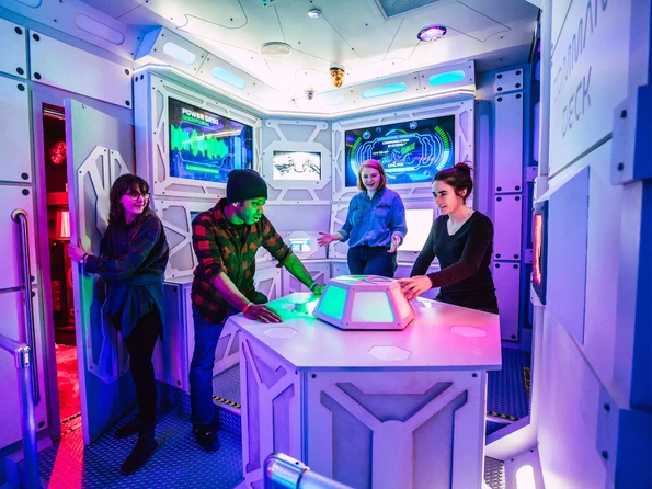 A group tries to figure out how to escape a high tech room at The Escape Game in Orlando.