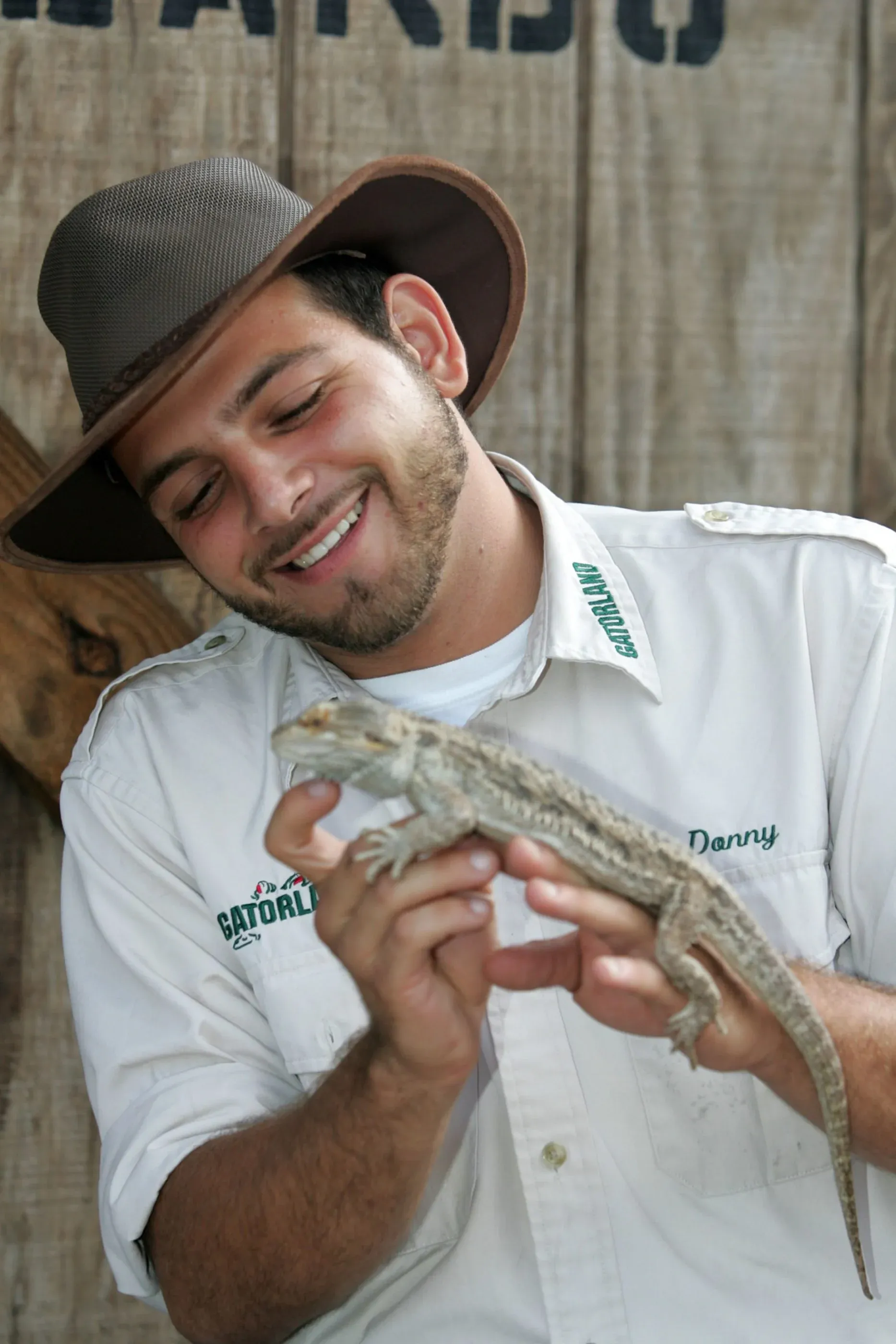 A staff member holds a lizard at Gatorland, a popular thing to do in Orlando, Florida.