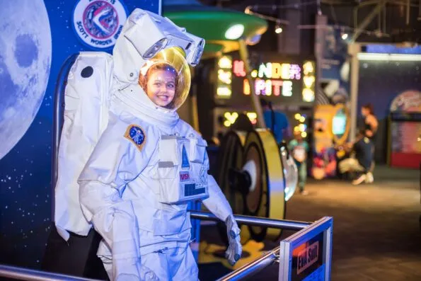 A child wears an astronaut costume at WonderWorks, an Orlando attraction.