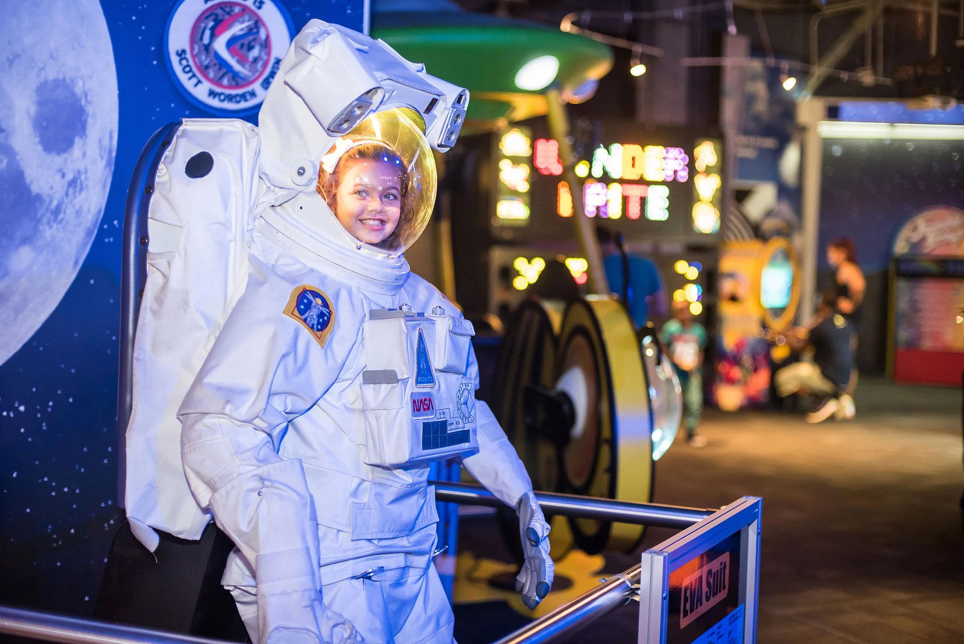 A child wears an astronaut costume at WonderWorks, an Orlando attraction.