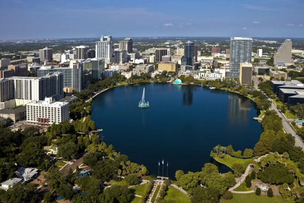 Aerial view of Lake Eola with surrounded by green space and city buildings in the background.