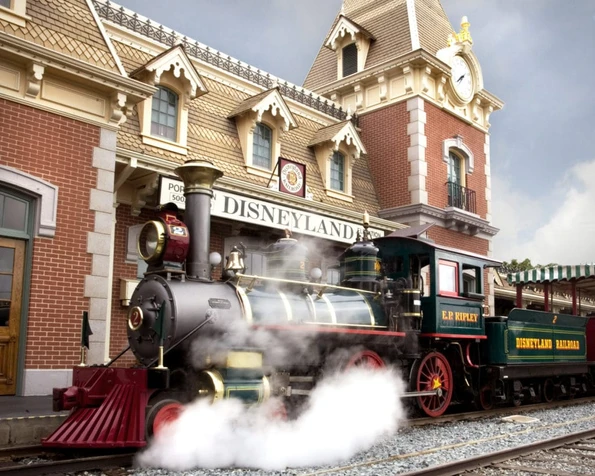 Disneyland Railroad train with the Main Street U.S.A. station in the background.