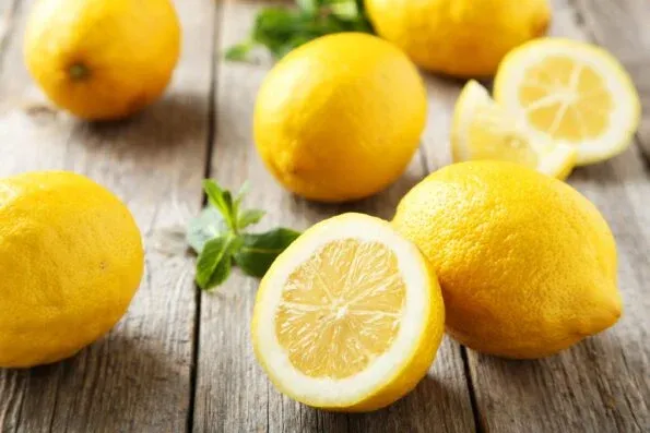 Pretty lemons on a wooden background.