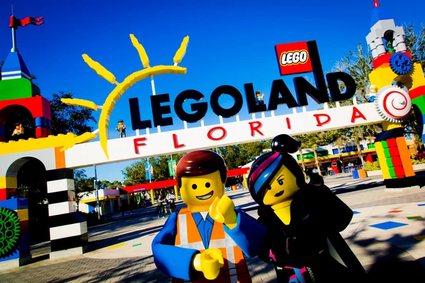 LEGO characters stand in front of the LEGOLAND Florida entrance.