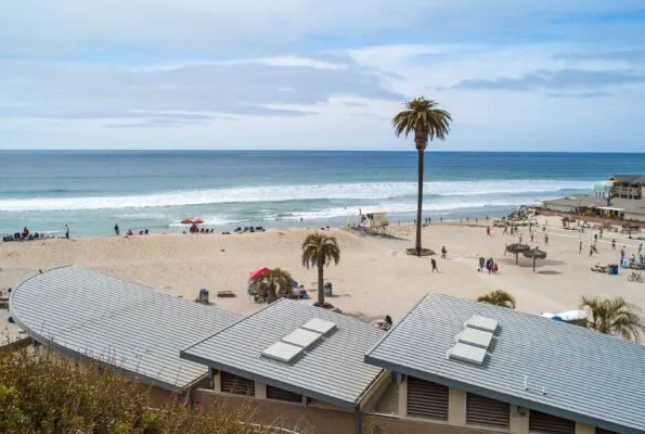 View of the beach volleyball courts and ocean at Moonlight Beach in Encinitas, one of our top picks for San Diego kid-friendly beaches.