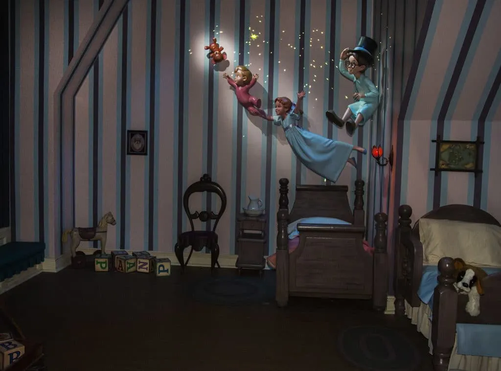 Kids fly in the nursery during Peter Pan's Flight.