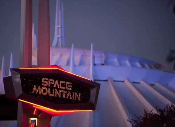 The Space Mountain sign in front of the ride's famous galactic mountain dome.