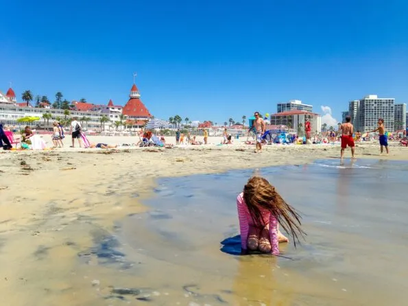 My daughter plays in the sand at Coronado Central Beach in front of Hotel del Coronado.