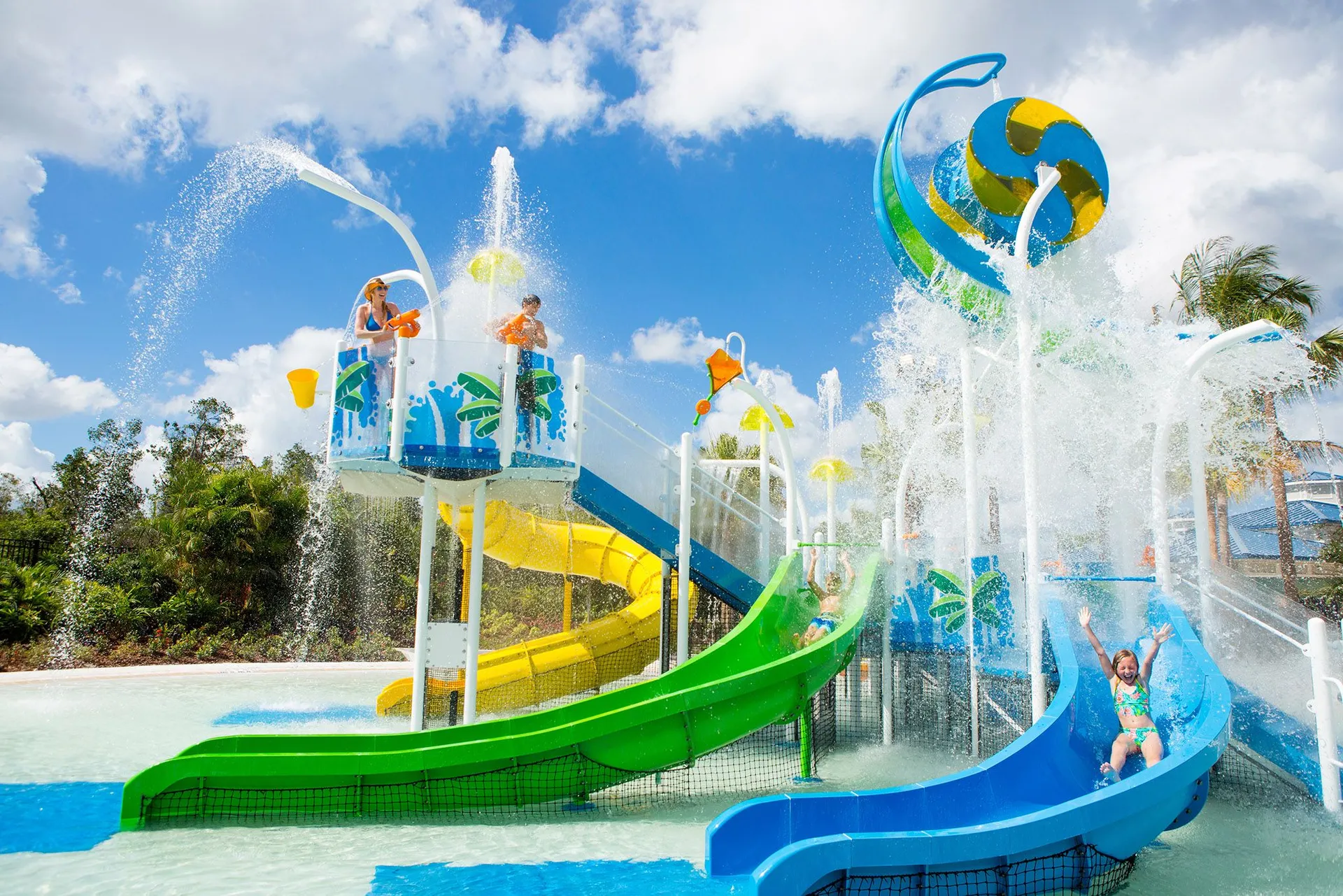 Kids enjoy the small water slide and water play area at The Grove 