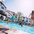 Kids jump into the Villa Pool