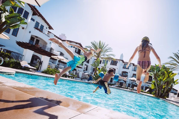 Kids jump into the Villa Pool