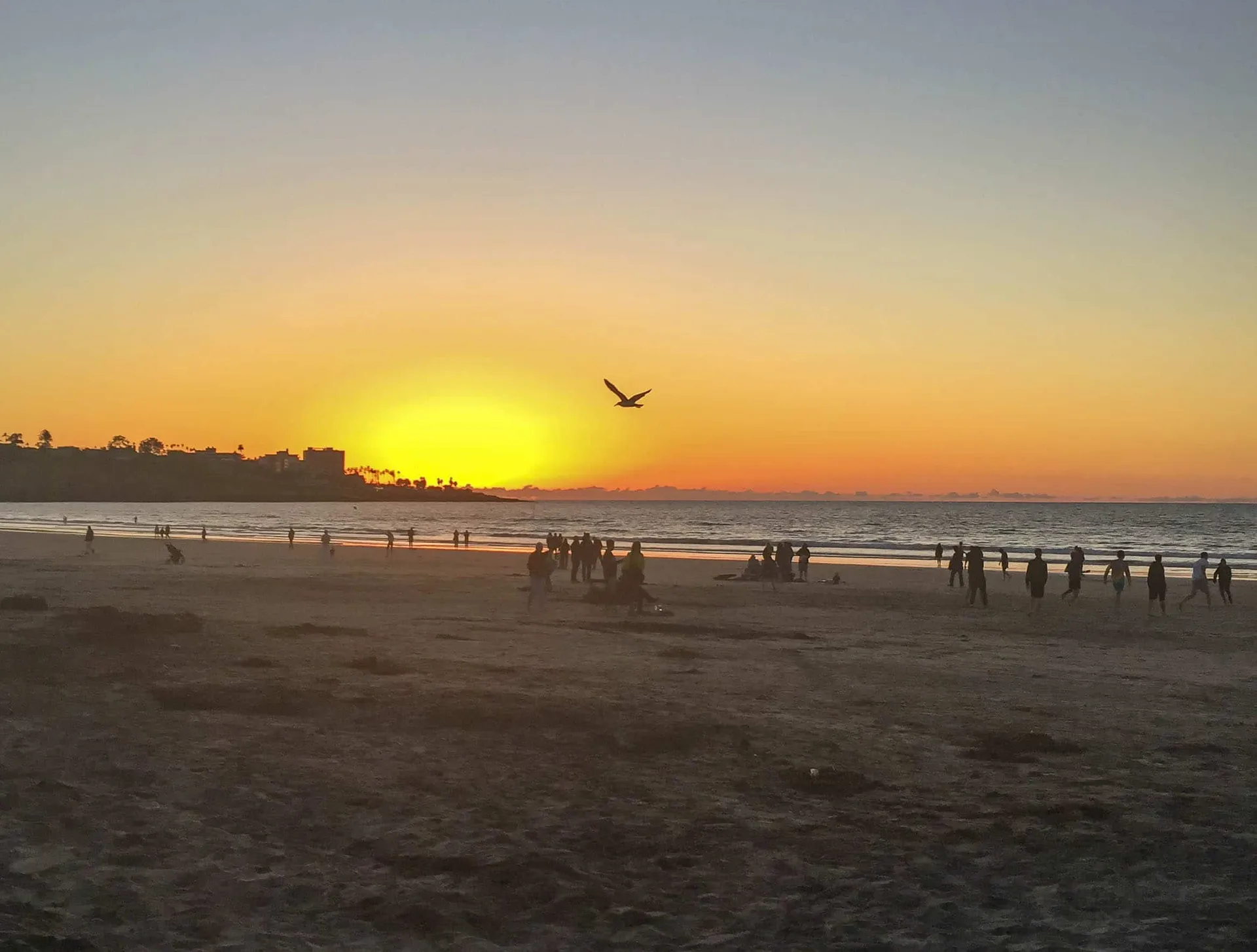 Sunset over the ocean as seen from the beach.