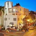 Exterior night view of La Pensione Little Italy San Diego hotel.