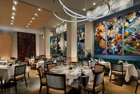 Inside tables and artwork at NINE-TEN Restaurant in Grande Colonial La Jolla