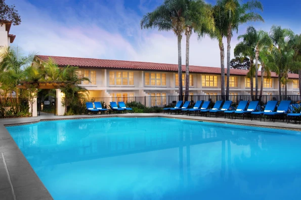 A Garden Pool surrounded by blue lounge chairs