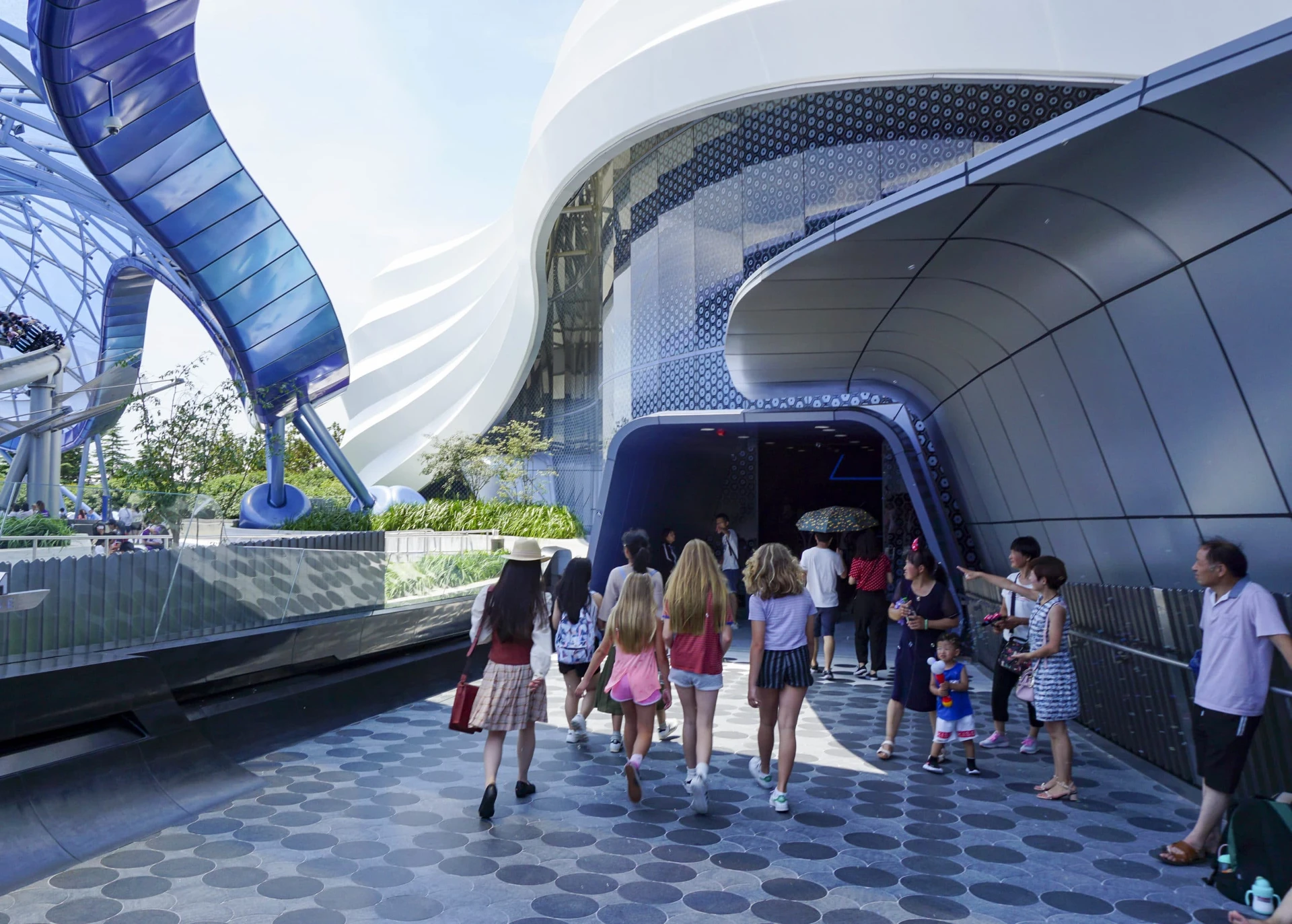 A Shanghai Disneyland tour guide leads us into the TRON ride.