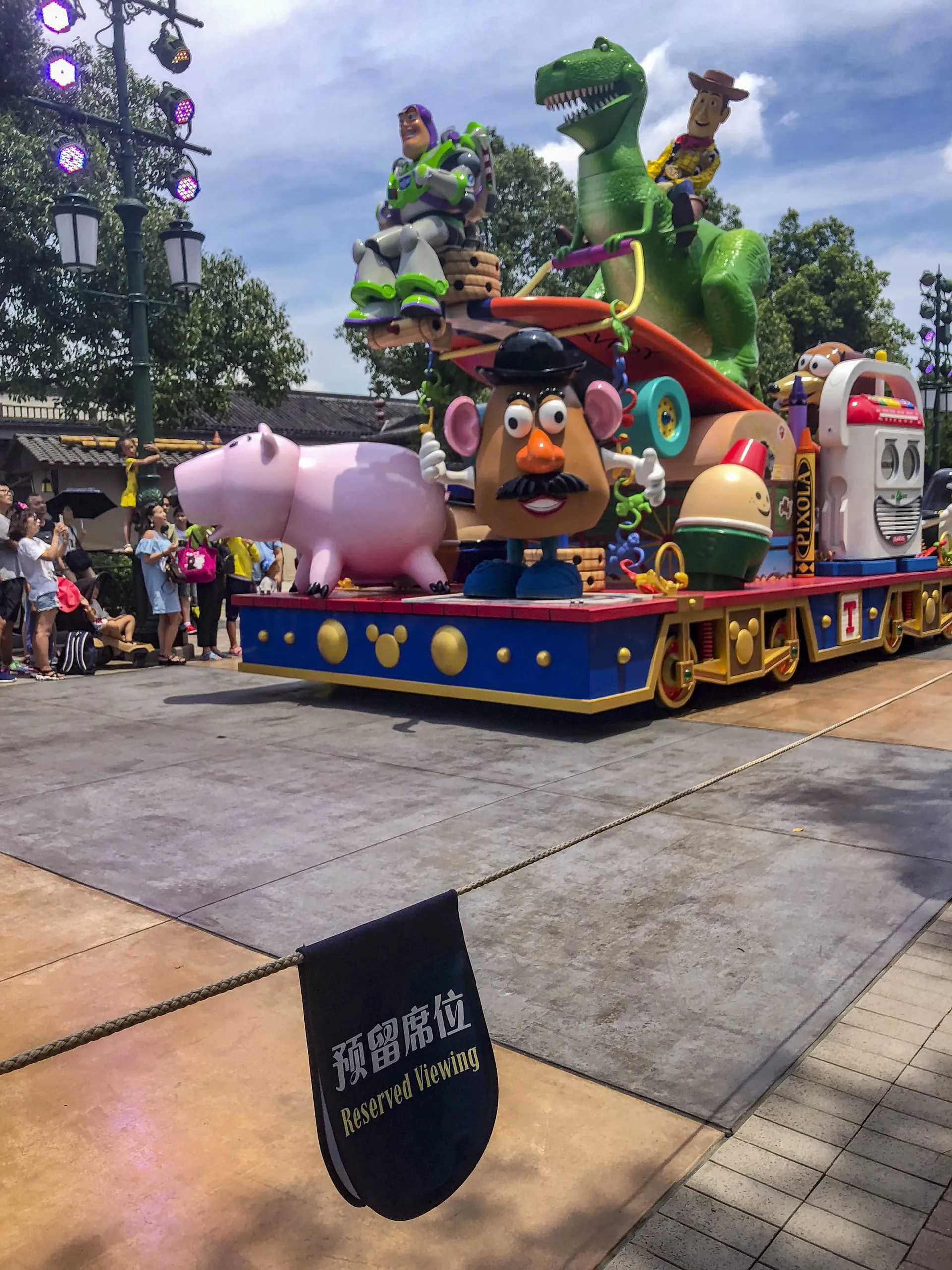 A Toy Story float passes by the reserved seating area for VIP tour guests at Shanghai Disneyland.