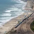 View of crowds enjoying Torrey Pines State Beach, a popular Del Mar Beach.