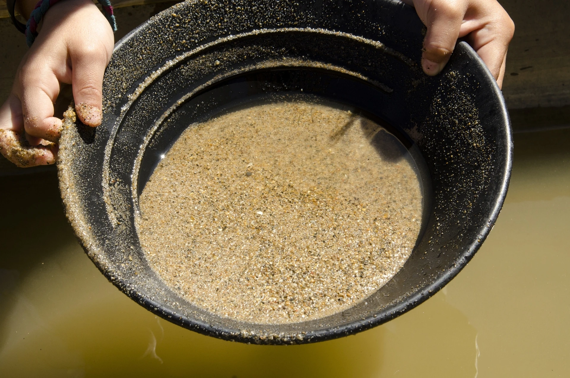 A child pans for gold, one of the popular things to do in Julian, CA for families.
