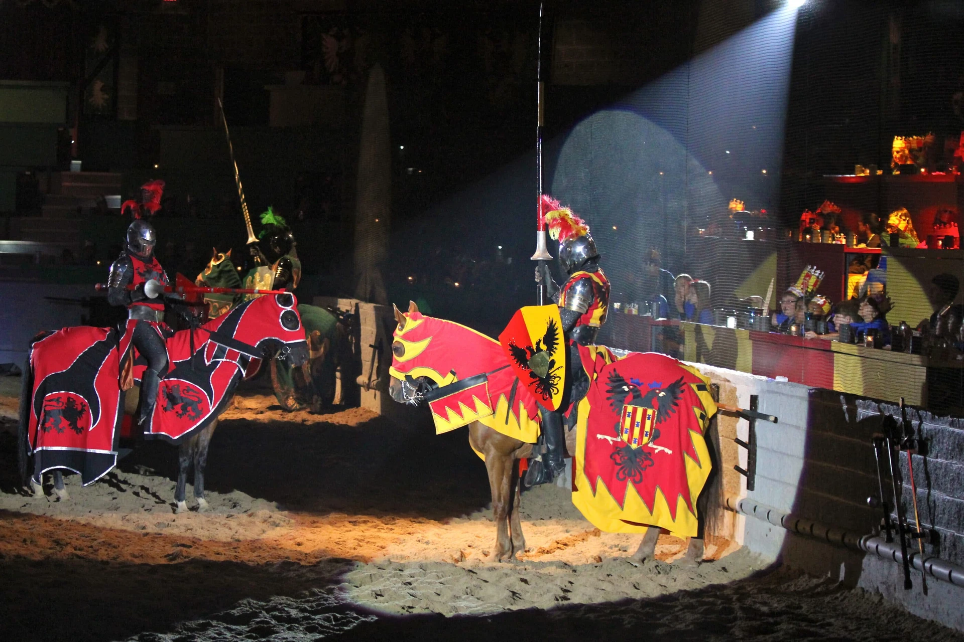 Knights on horses face each other in the arena as diners watch at Medieval Times.
