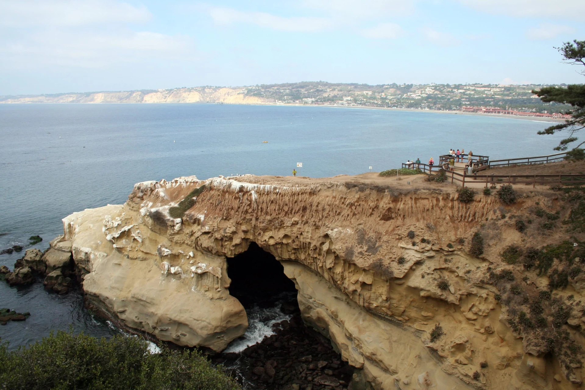 People stand on the trail and viewing platform on Goldfish Point in La Jolla.