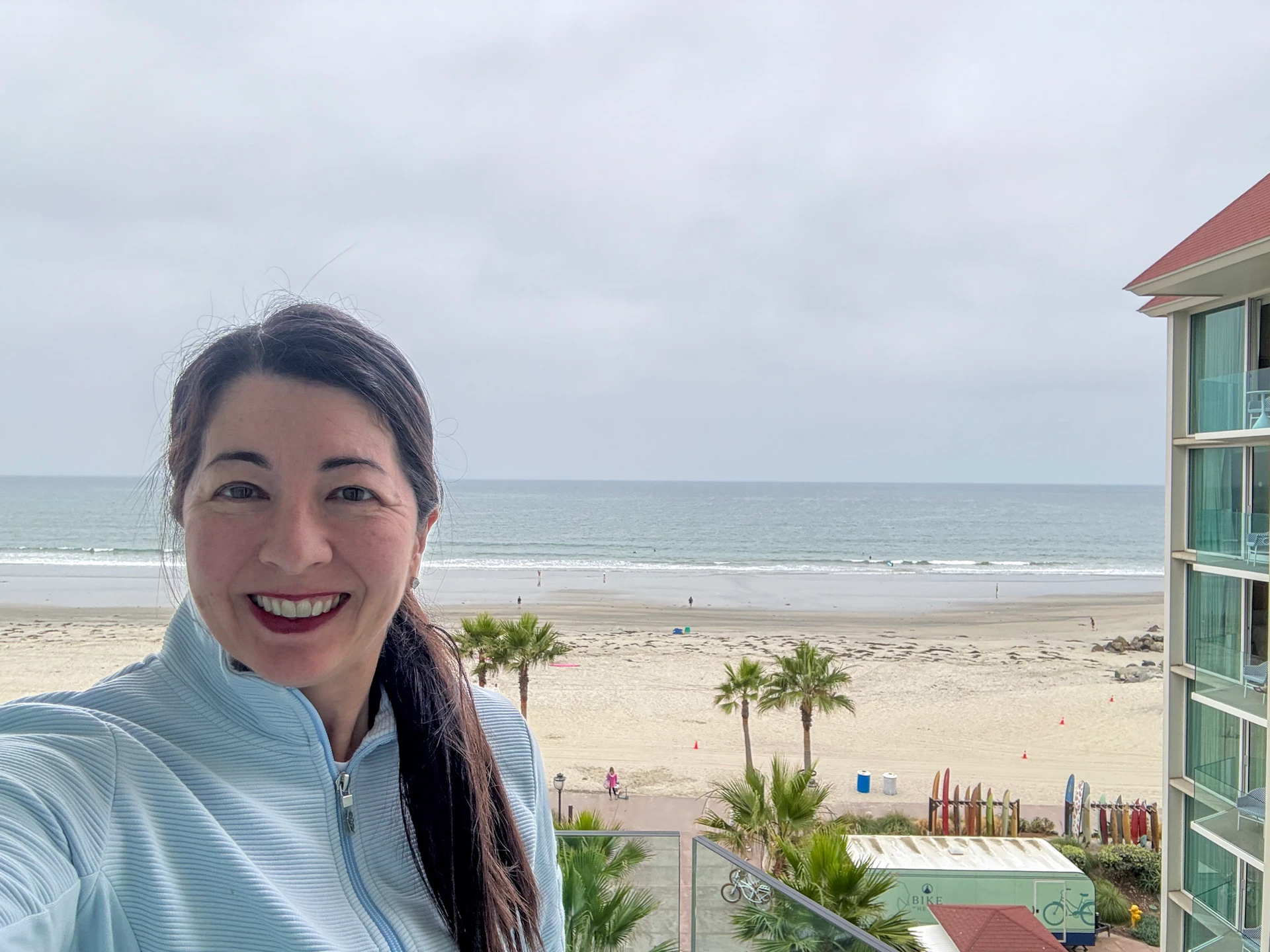 Katie Dillon stands on her The Views Oceanfront balcony .