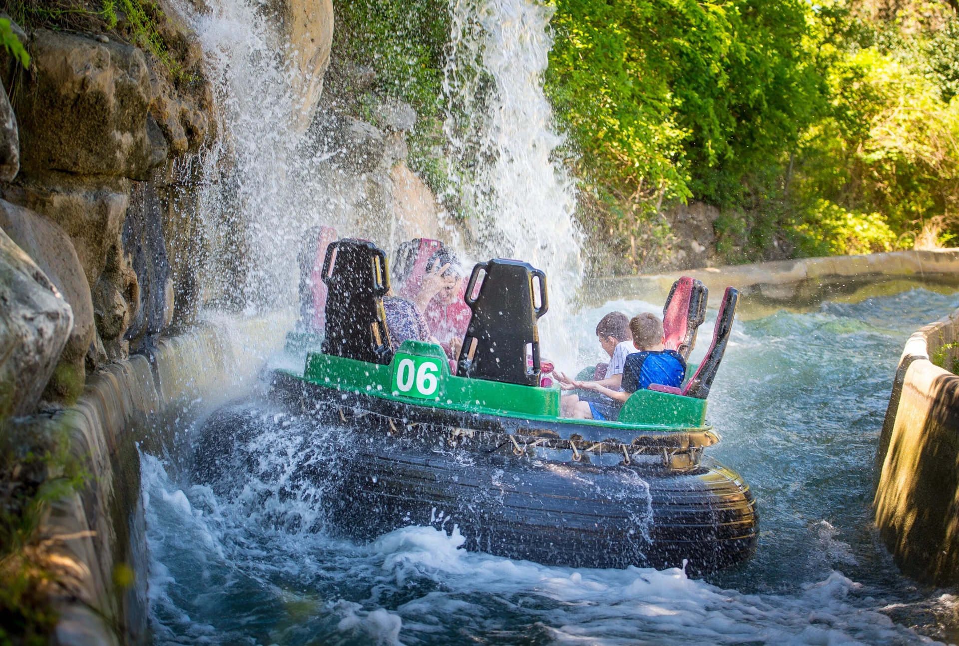 A Rio Loco raft spins under a waterfall at SeaWorld San Antonio