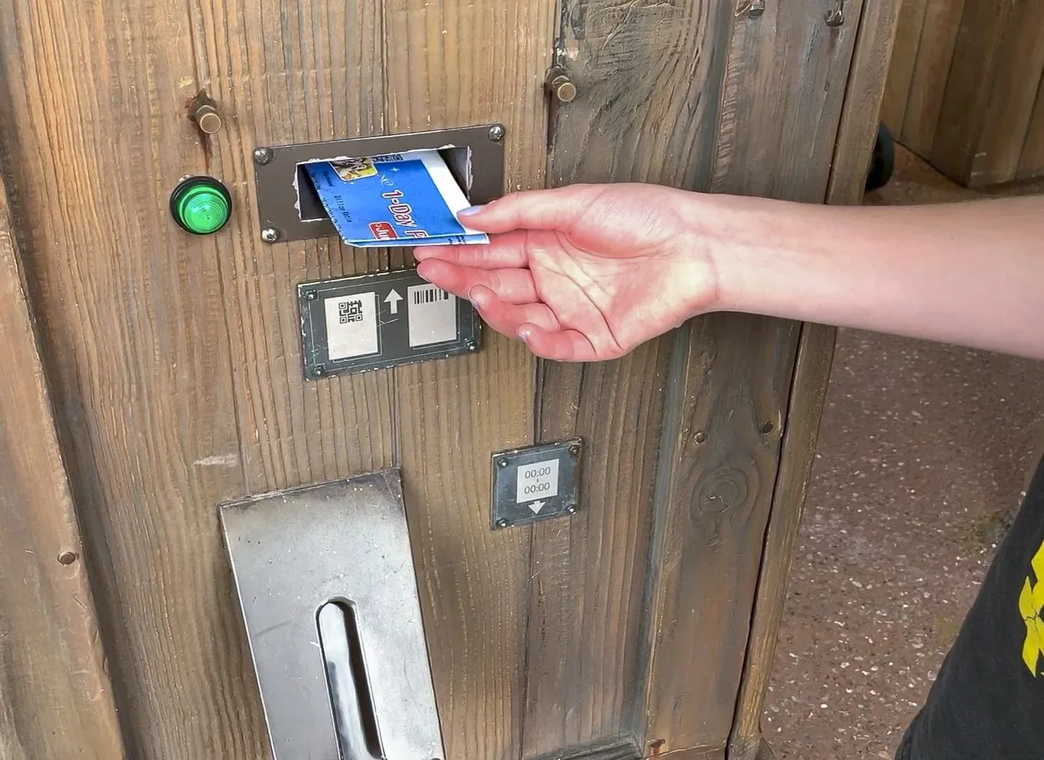 A ticket is inserted into a Fastpass maching.