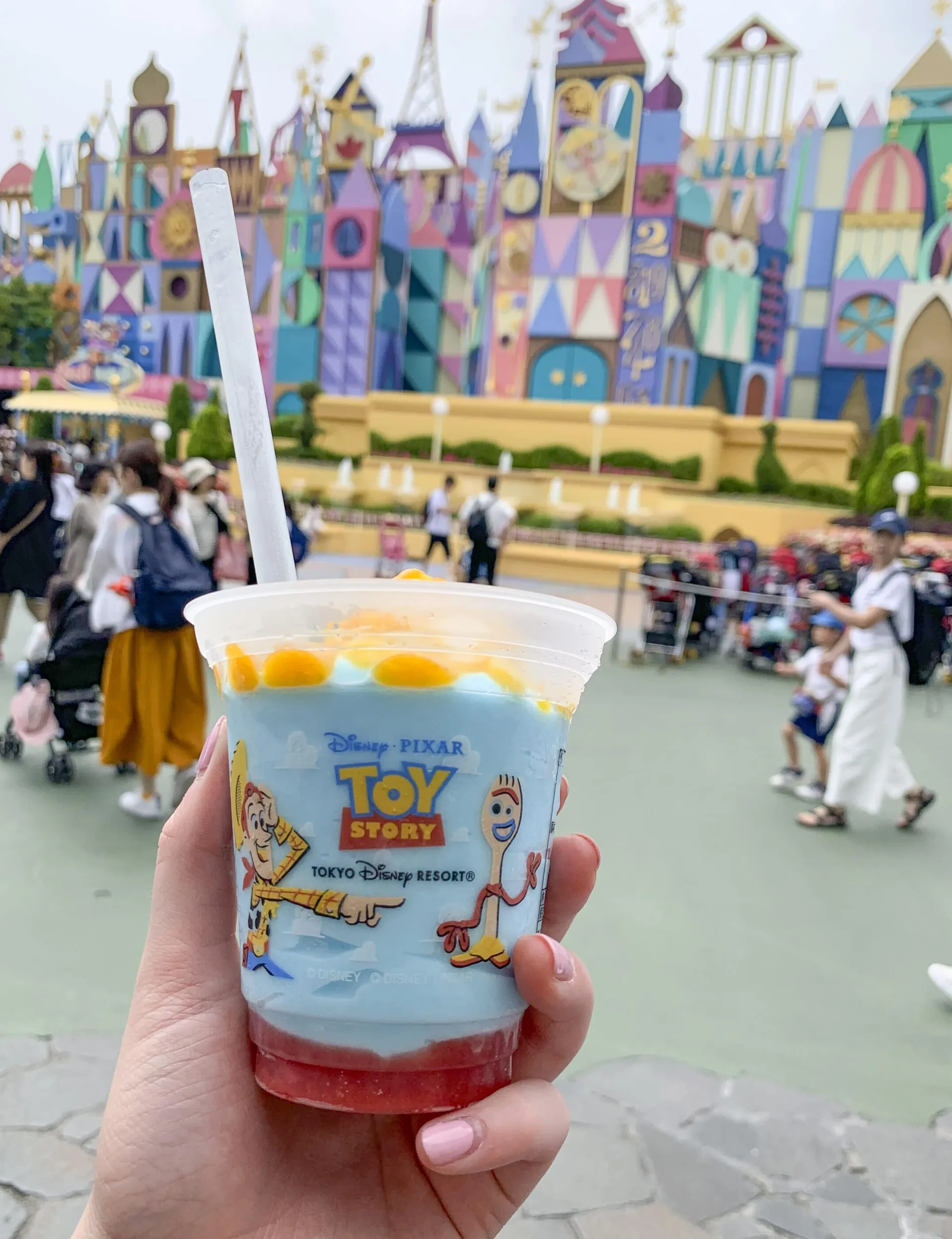 An ice cream from the cart in front of it's a small world.