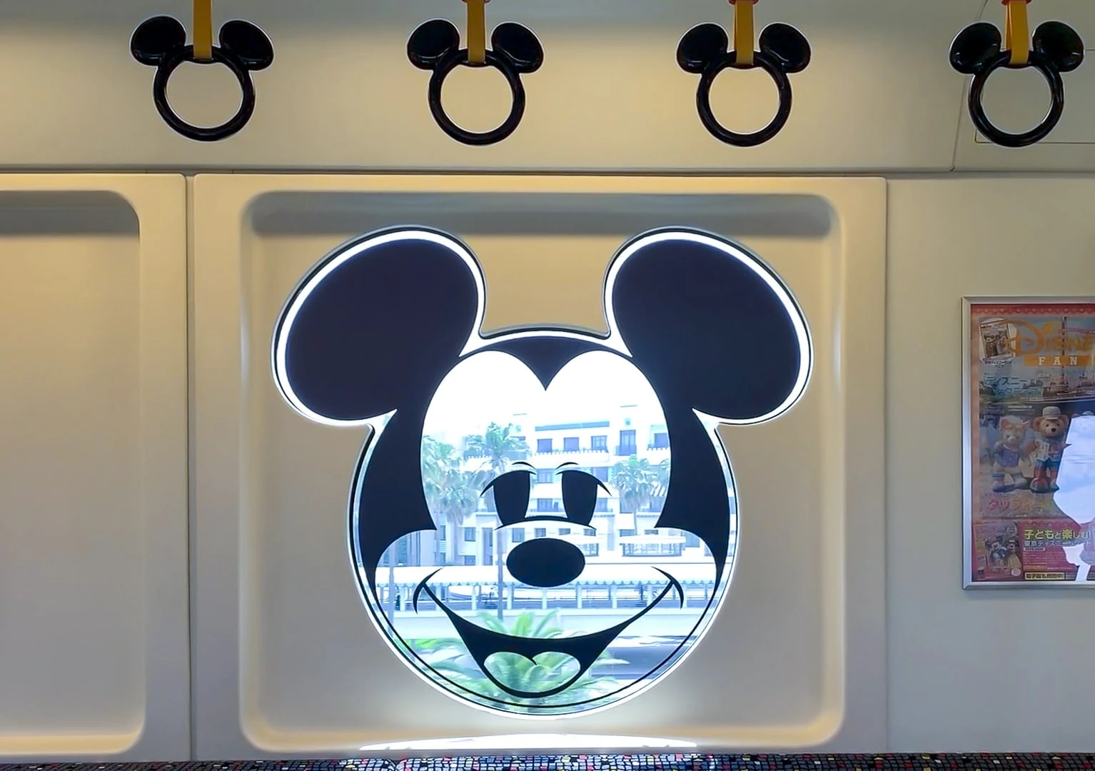 Micky Mouse windows and hand holders in the monorail train.
