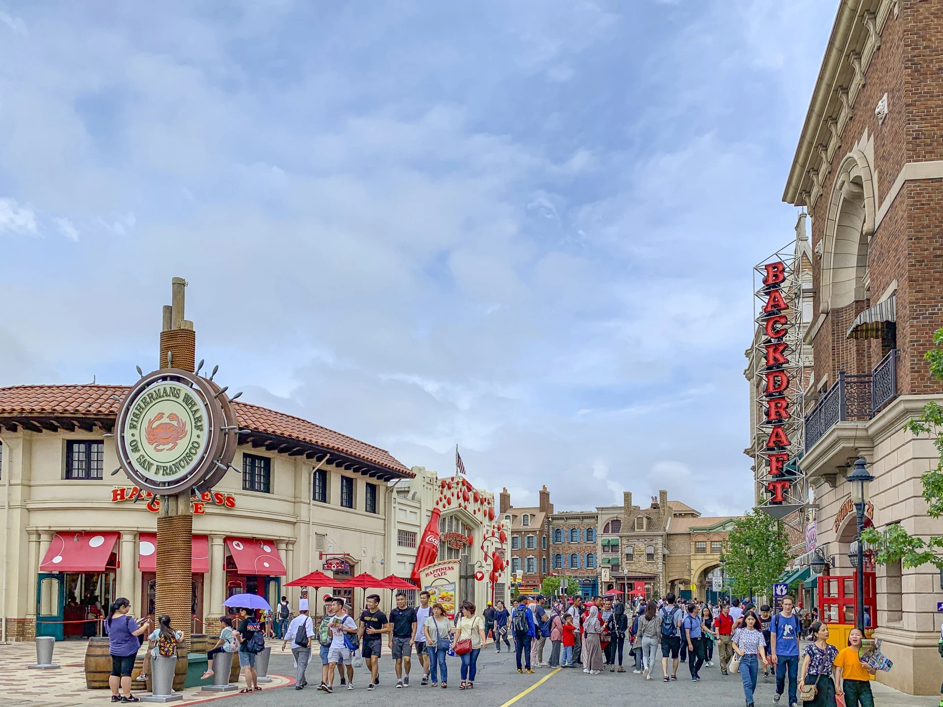 People walk down the street through San Francisco Land at Universal Studios Japan.