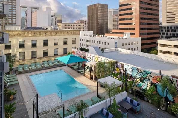 Aerial view of the Alma San Diego pool deck with loungers and mural.