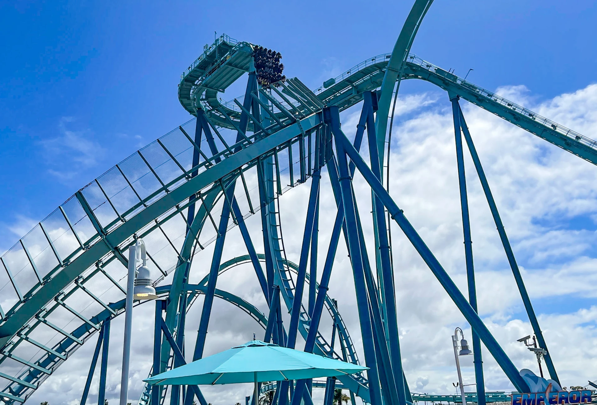 The Emperor roller coaster with riders about to drop down a steep drop.