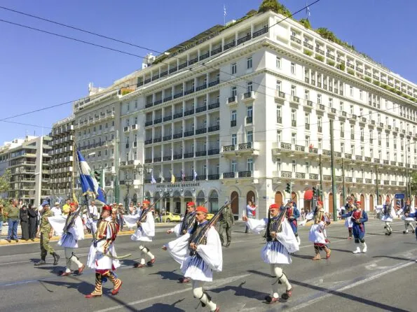 Changing of the guards ceremony walks by Hotel Grande Bretagne.