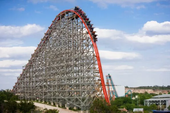 The Iron Rattler roller coaster at Six Flags Fiesta Texas hurls down a steep drop.