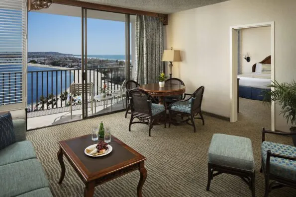 Bay View Suite showing the separate bedroom, four-person table, balcony and bay view.