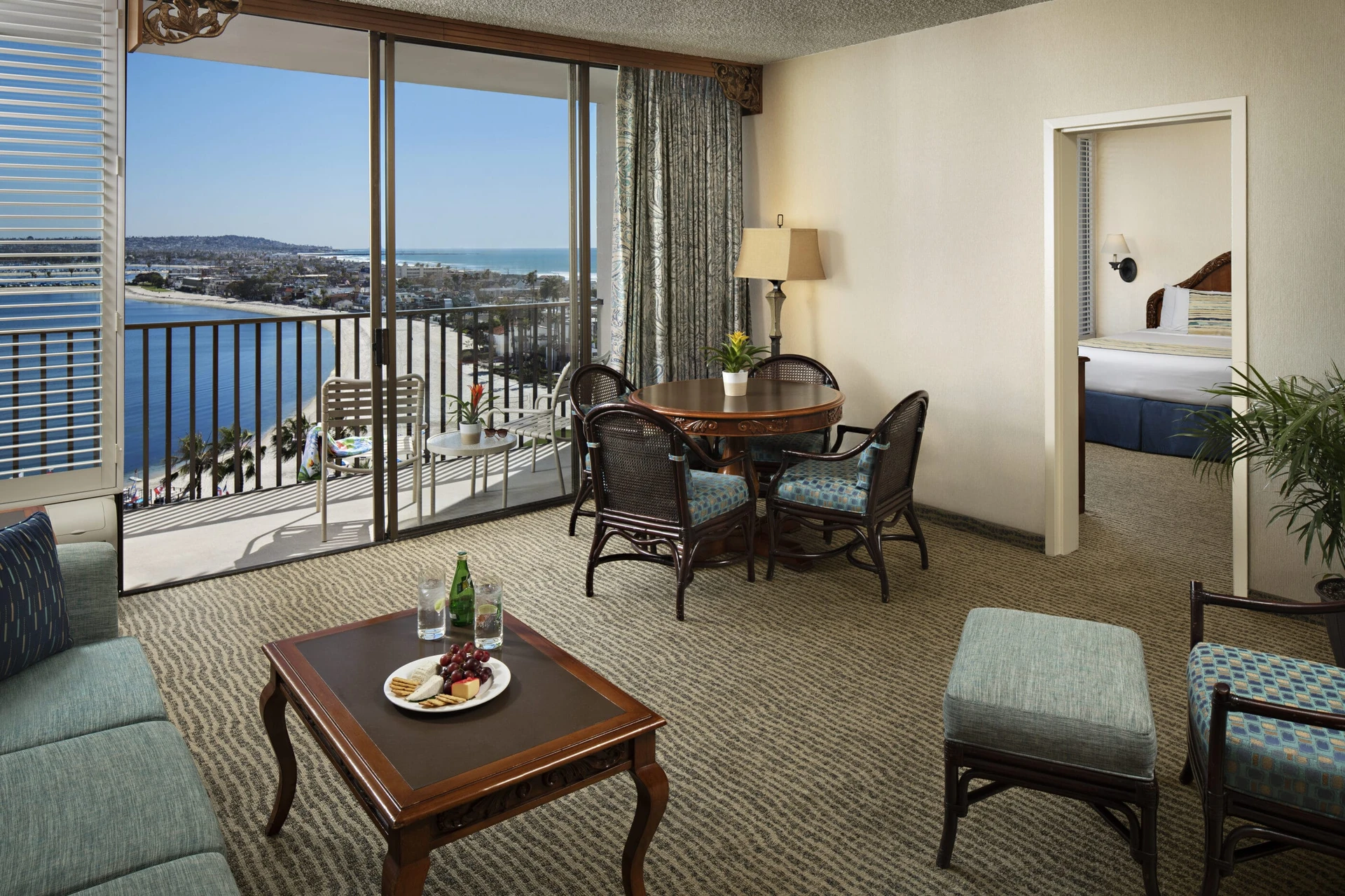 Bay View Suite showing the separate bedroom, four-person table, balcony and bay view.