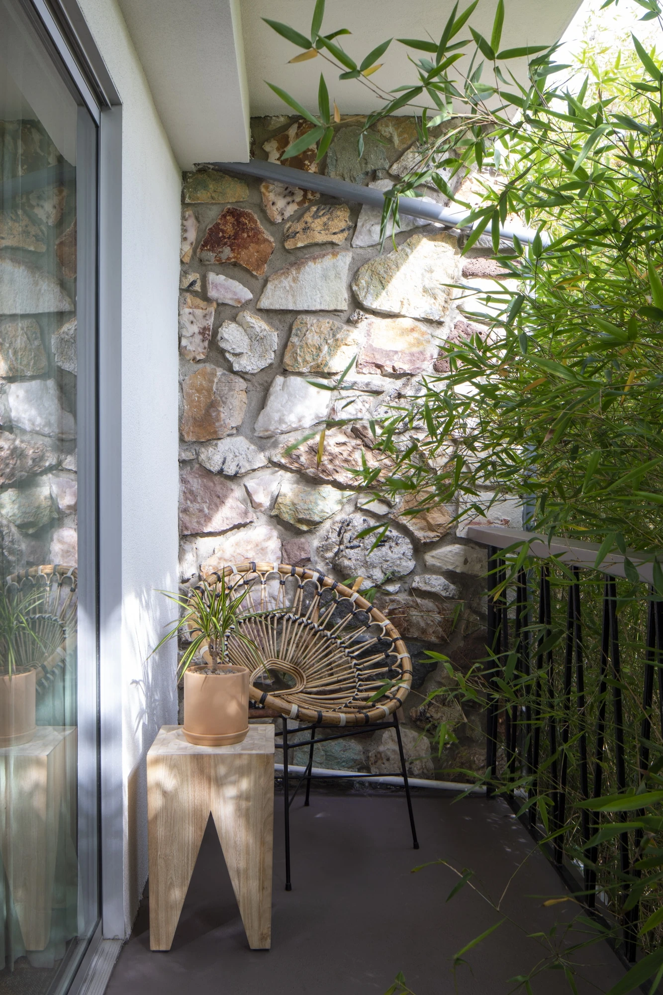 Seating and a wooden table on a balcony of a Grand Pearl room.