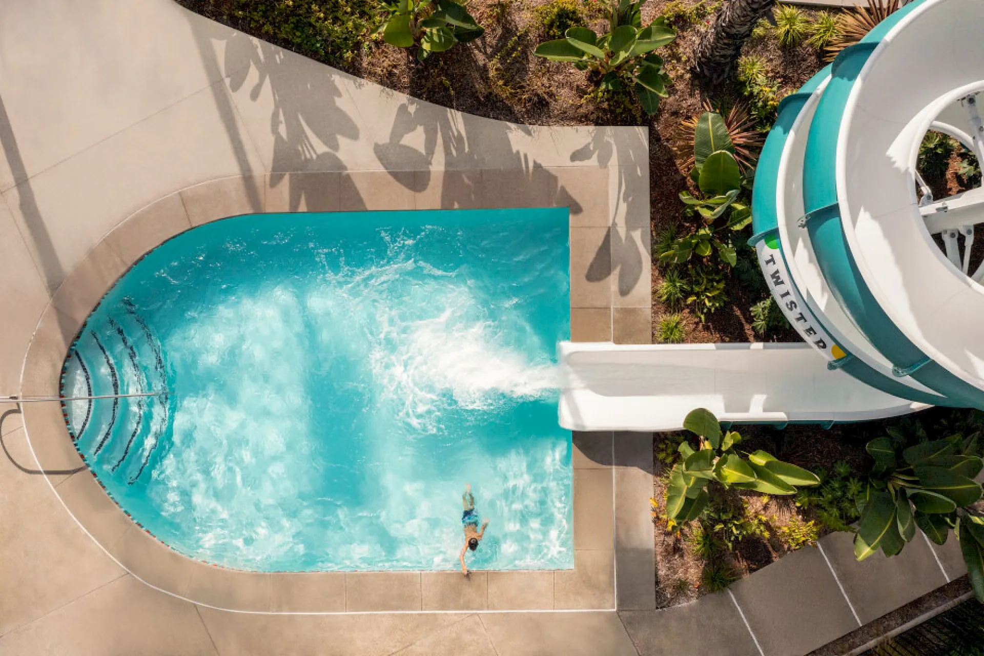 A child climbs out of the pool after riding the water slide at Town and Country Resort.