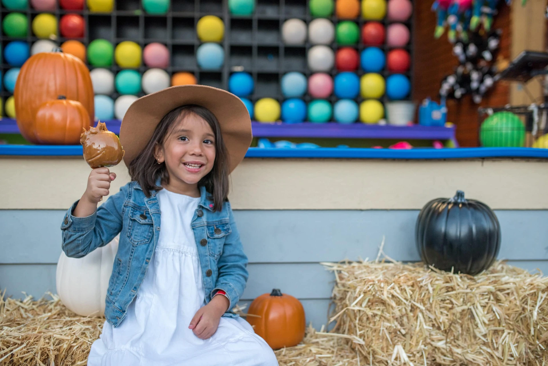 A girl eats a candy apple at Harvest Walk.