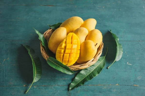Mango in a basket on a green wood