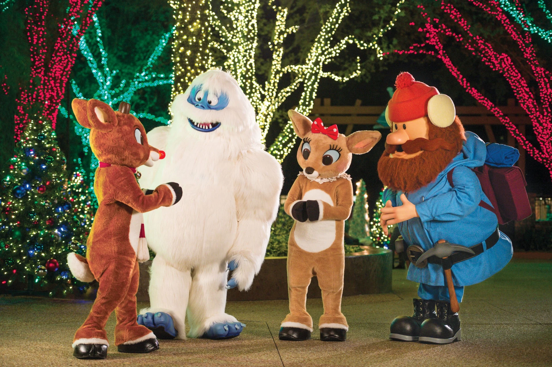 Rudolph and friends in front of holiday decor at SeaWorld San Diego's Christmas Celebration.