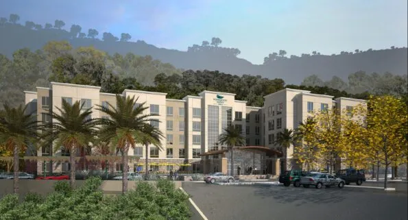 Exterior of the Mission Valley hotel set against the hillside.