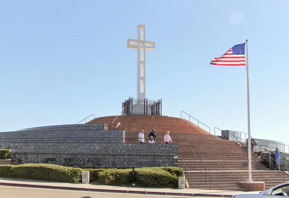View of the Mount Soledad cross surrounded by memorial walls at its base.