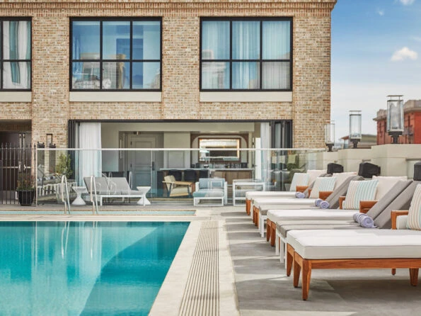 Lounge chairs surround the pool at Pendry San Diego hotel.