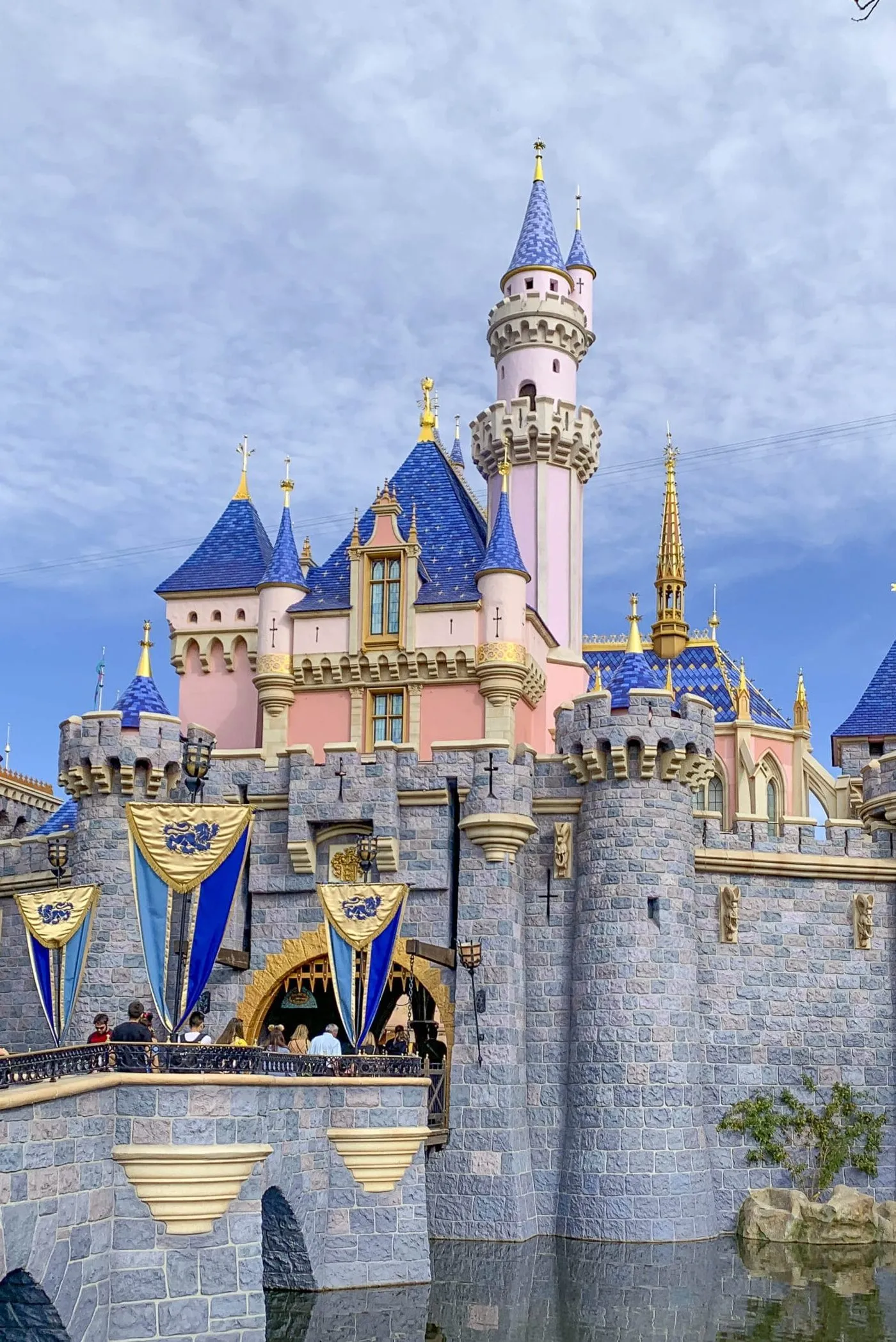 Guests walk through Sleeping Beauty's Castle at Disneyland.